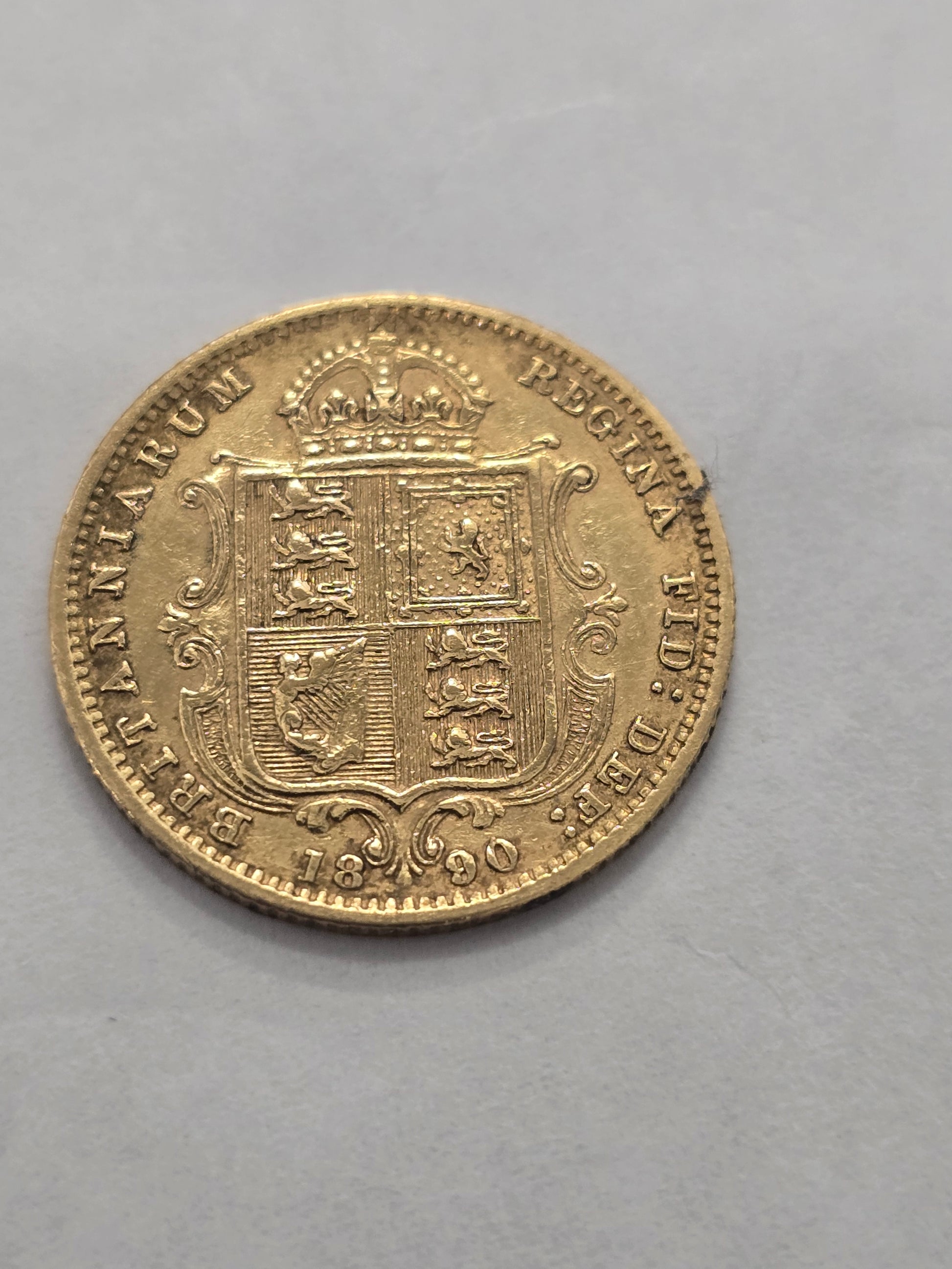 Gold coin featuring Queen Victoria, 1890 Half Sovereign, Reeves and Sons, with detailed portrait and ornate design.