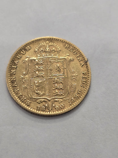 Gold coin featuring Queen Victoria, 1890 Half Sovereign, Reeves and Sons, with detailed portrait and ornate design.