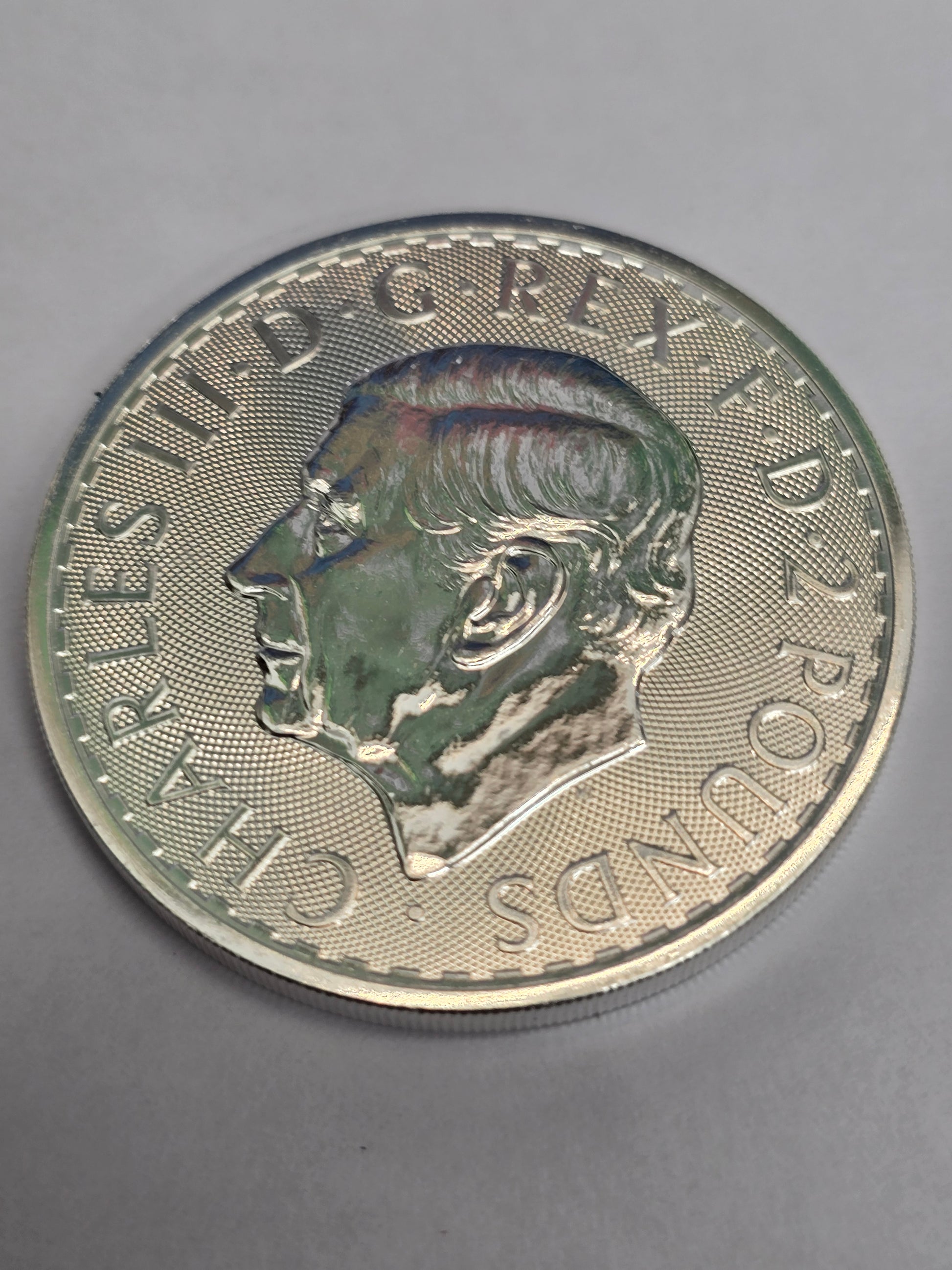 Silver 1oz 2025 Britannia coin by Reeves and Sons, featuring the £2 denomination and fine 999 silver finish.