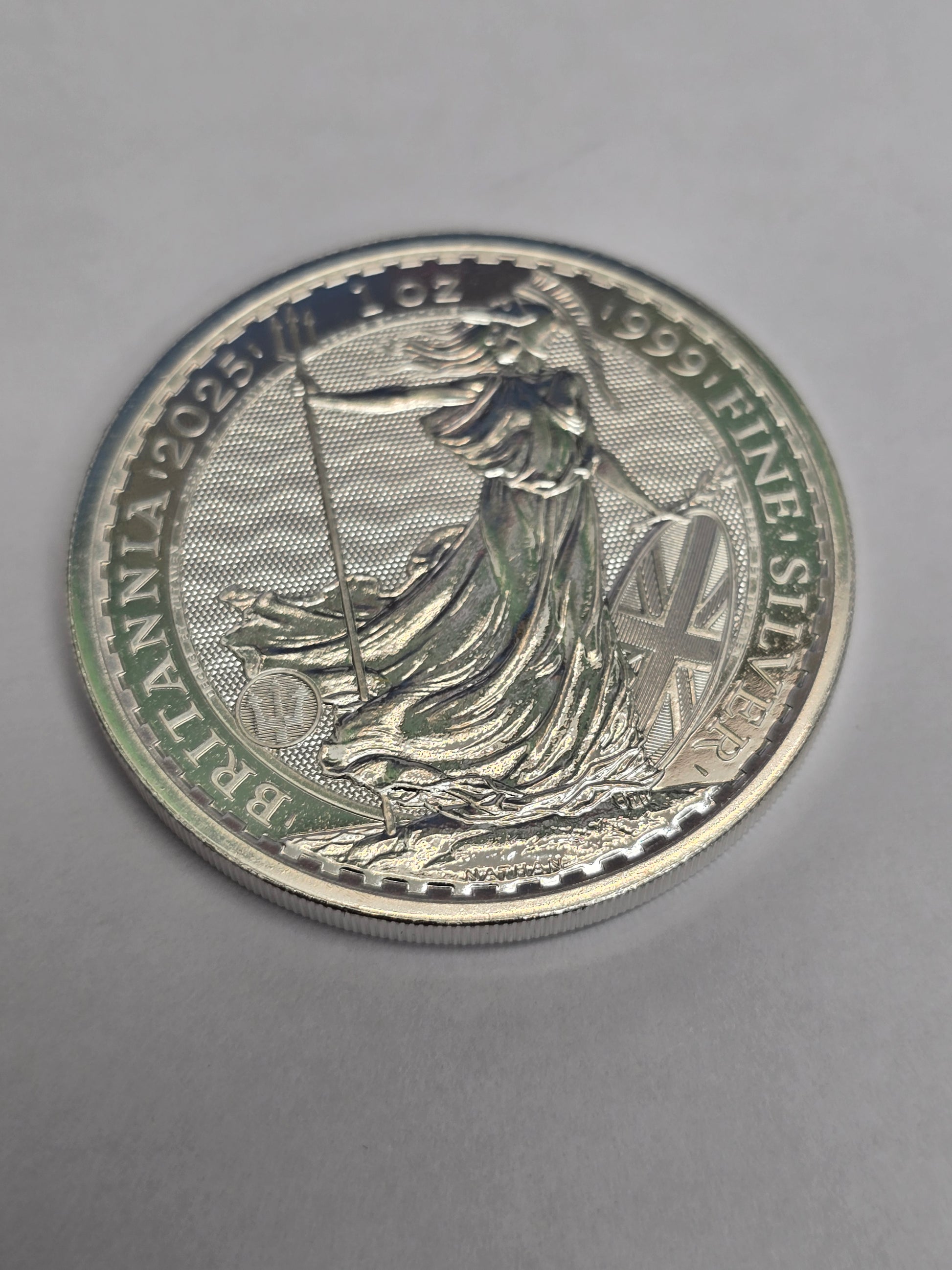 Silver 1oz 2025 Britannia coin by Reeves and Sons, featuring fine silver £2 coin with Britannia design on the obverse.