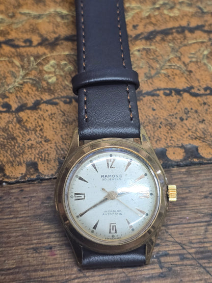Vintage Ramona 30 Jewels Incabloc automatic Swiss watch by Reeves and Sons, showing the watch face with gold-tone details.