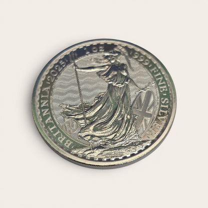 Silver 1oz 2025 Britannia coin by Reeves and Sons, featuring fine silver £2 coin with Britannia design and detailed imagery.