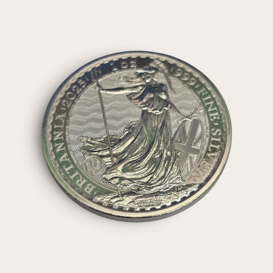 Silver 1oz 2025 Britannia coin by Reeves and Sons, featuring fine silver £2 coin with Britannia design and detailed imagery.