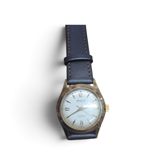 Vintage Ramona 30 Jewels Incabloc automatic Swiss watch by Reeves and Sons, showcasing the classic dial and stainless steel case.