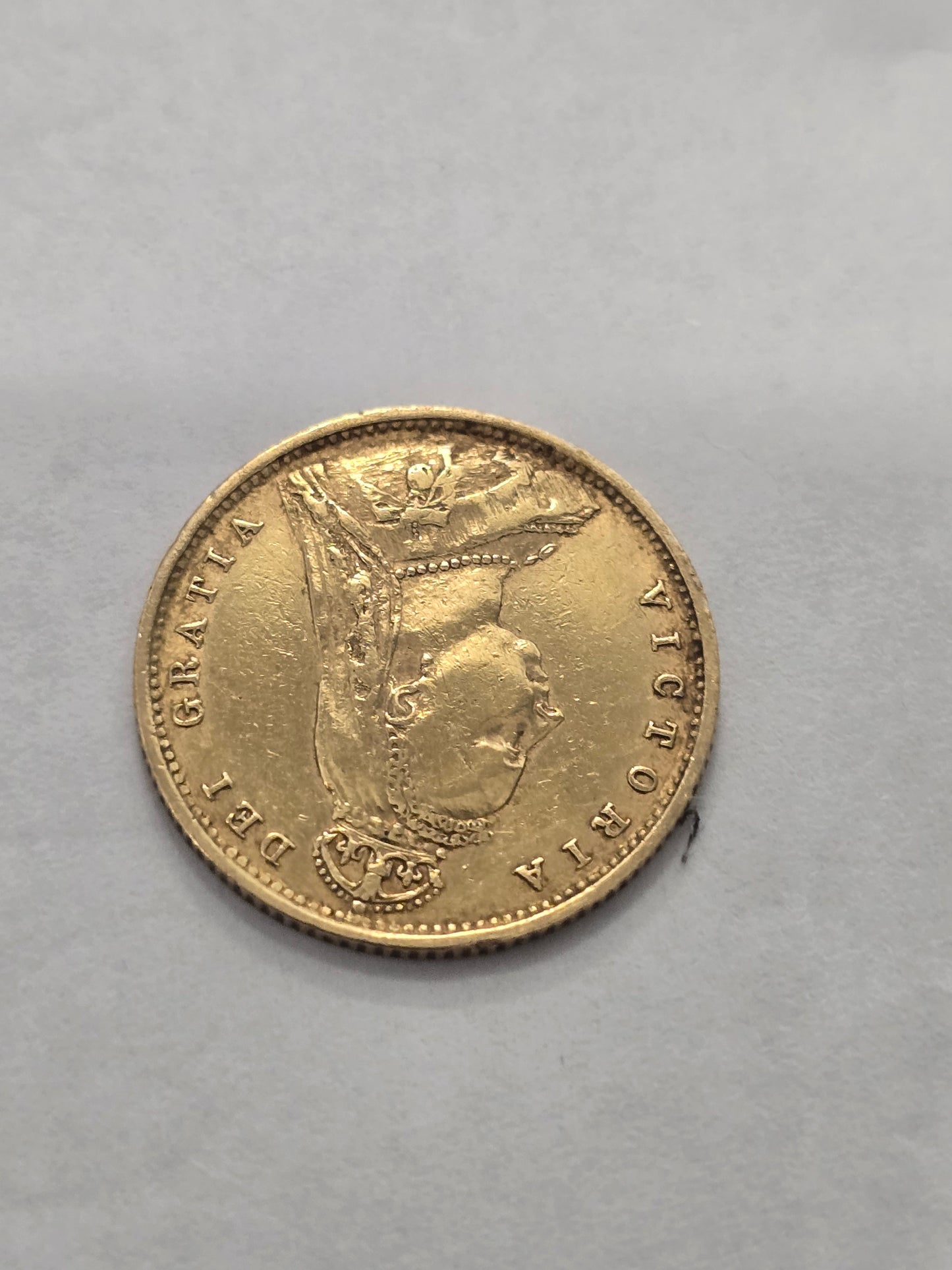 Gold 1890 Half Sovereign coin featuring Queen Victoria, issued by Reeves and Sons, with detailed obverse and reverse designs.