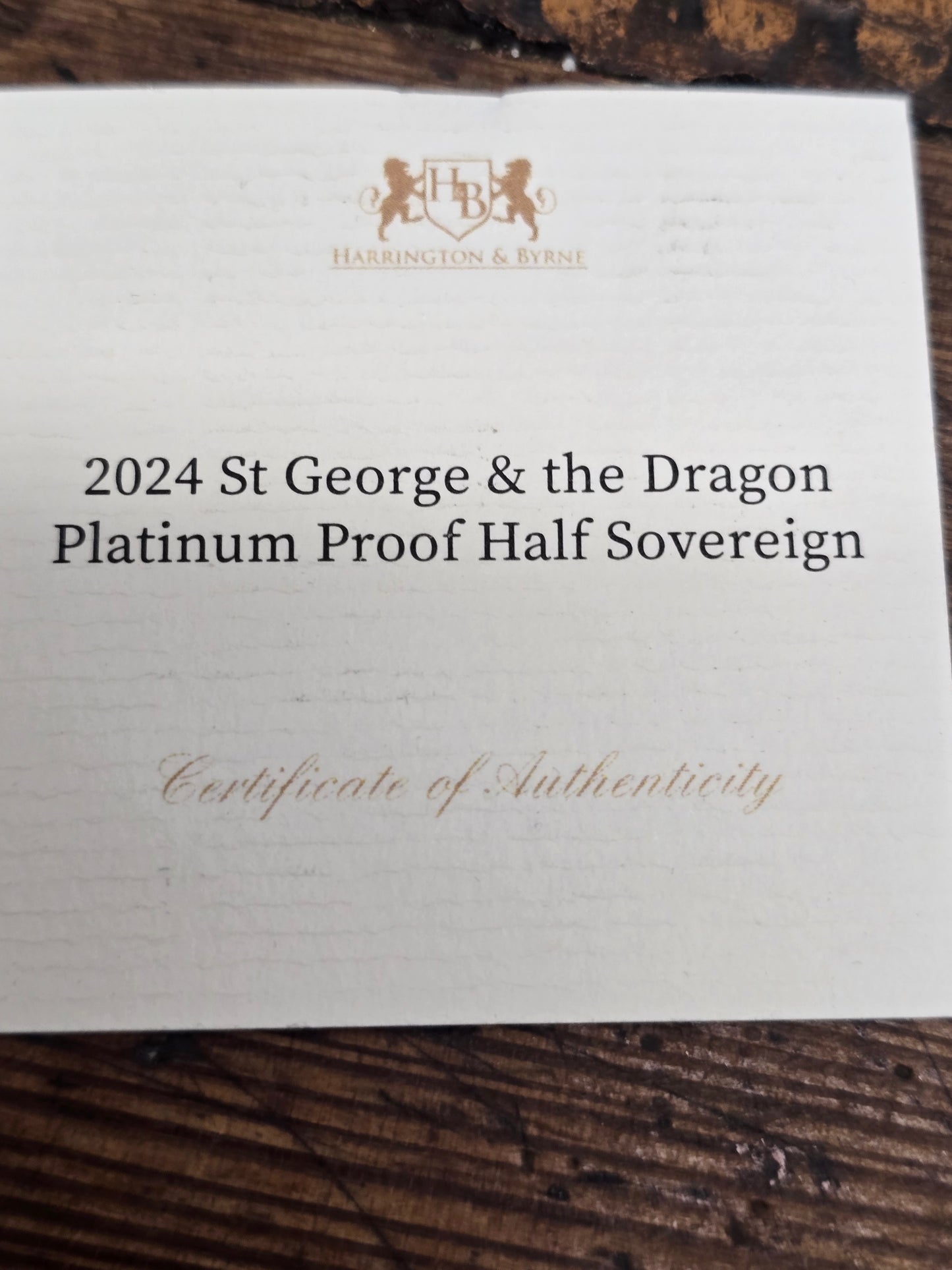 2024 Reeves and Sons St George & Dragon platinum proof half sovereign silver coin with certificate, featuring detailed coin design.
