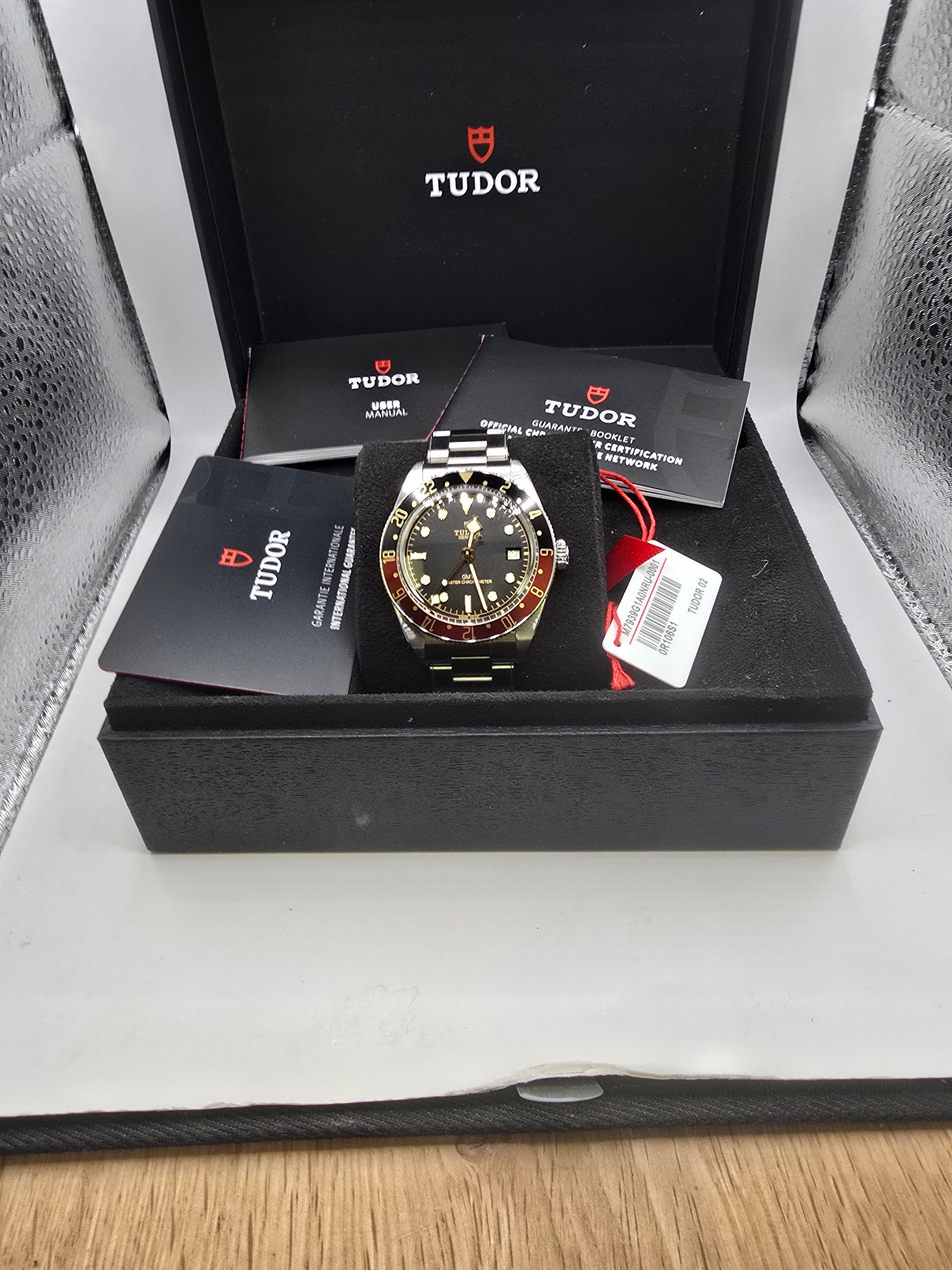 Tudor Black Bay 58 GMT Coke fullset watch from 2024, featuring a black and red bezel, stainless steel case, and black dial.