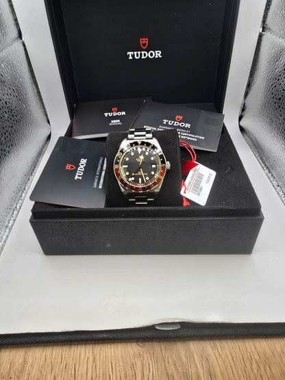 Tudor Black Bay 58 GMT Coke fullset watch from 2024, featuring a black and red bezel, stainless steel case, and black dial.