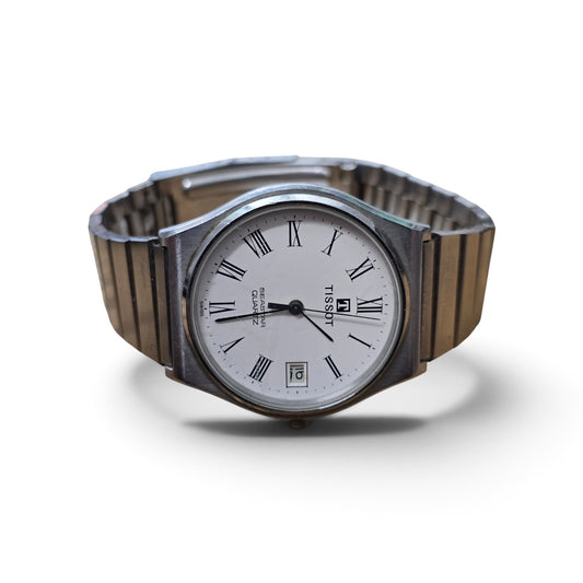 Vintage Tissot Seastar quartz watch with stainless steel band, white dial, Roman numerals, and date display.