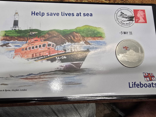 Silver proof £5 coin cover featuring the Harrington & Byrne 2021 lifeboat, branded by Reeves and Sons, displayed in protective packaging.
