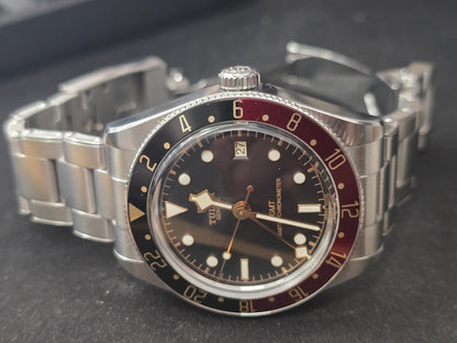 Tudor Black Bay 58 GMT Coke fullset watch from 2024 with black and red bezel, stainless steel case, and black dial.