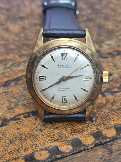 Vintage Reeves and Sons Ramona 30 Jewels Incabloc automatic Swiss watch with a classic design and stainless steel case.