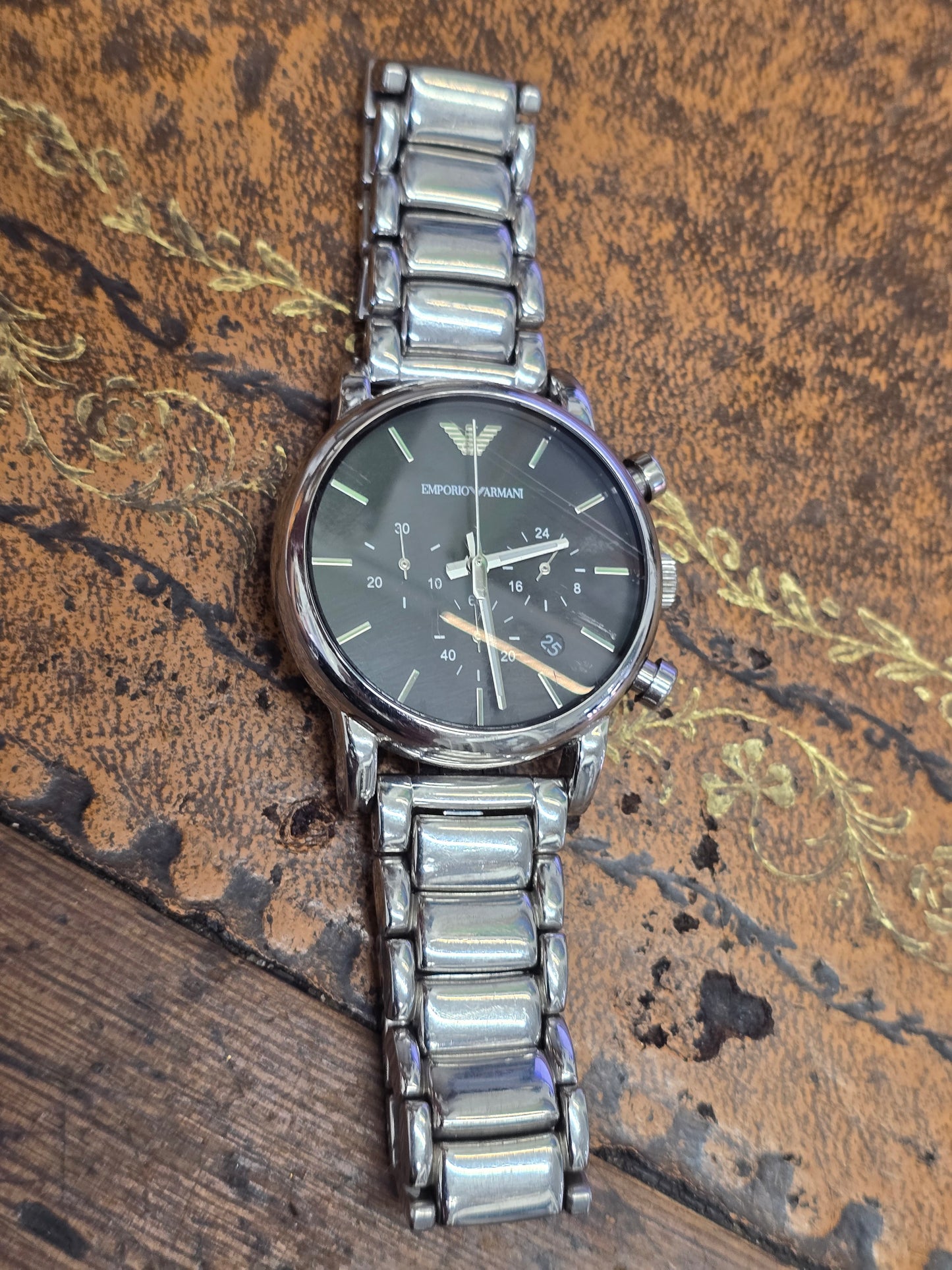 Emporio Armani men's stainless steel chronograph watch with black dial and silver case, showcasing a sleek, modern design.