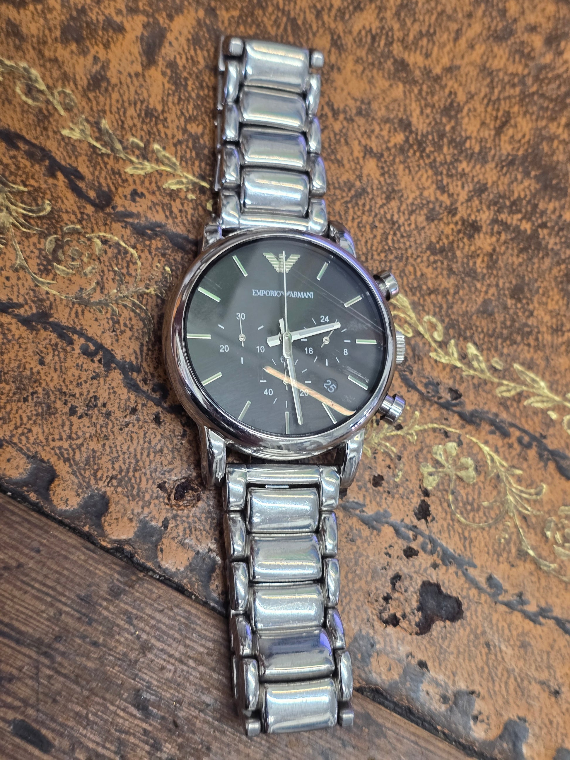 Emporio Armani men's stainless steel chronograph watch with black dial and silver case, showcasing a sleek, modern design.