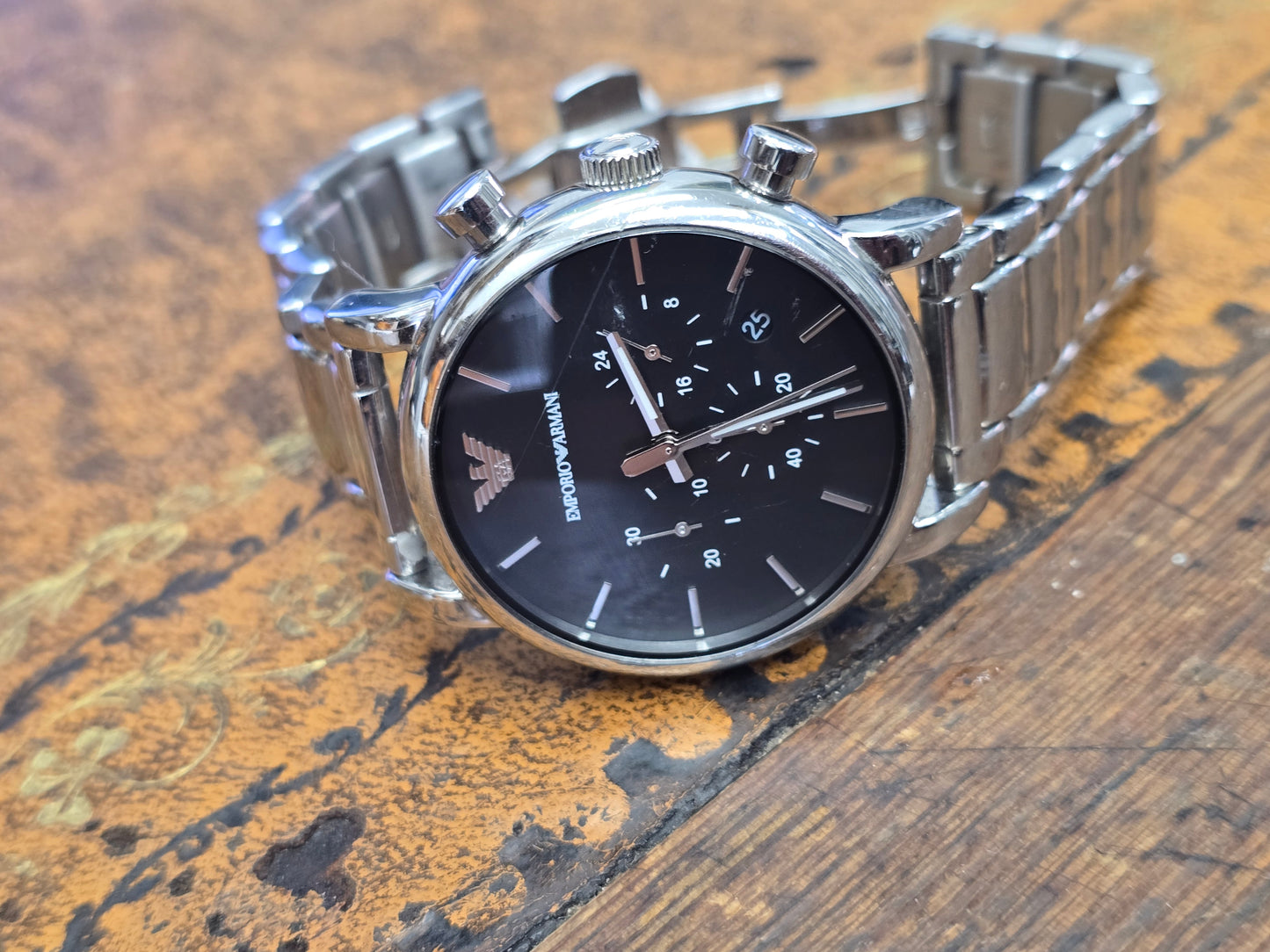 Emporio Armani men's stainless steel chronograph watch with black dial and silver-tone bracelet, showcasing a sleek, modern design.