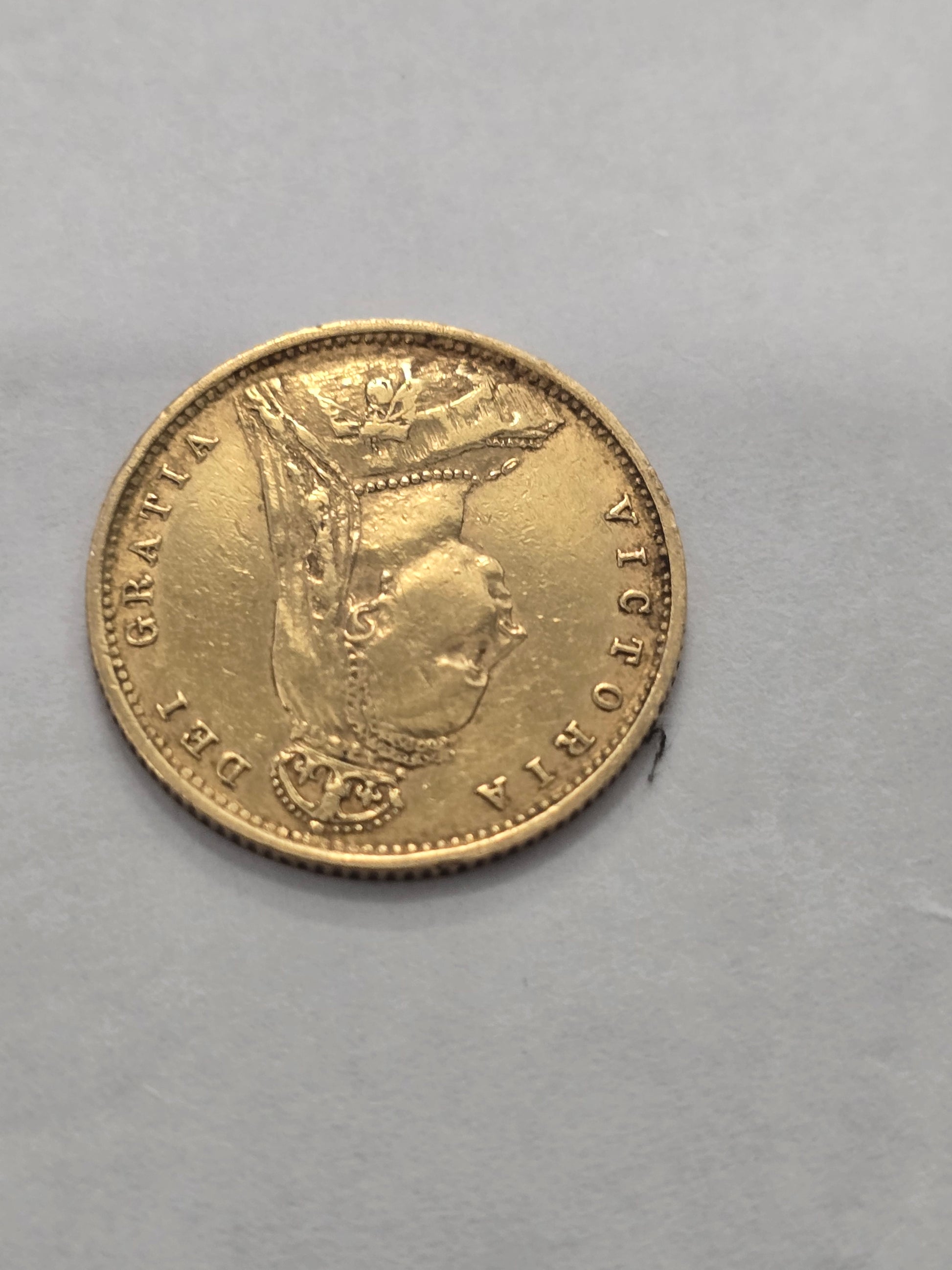 1890 Queen Victoria half sovereign gold coin by Reeves and Sons, featuring detailed portrait and inscriptions.
