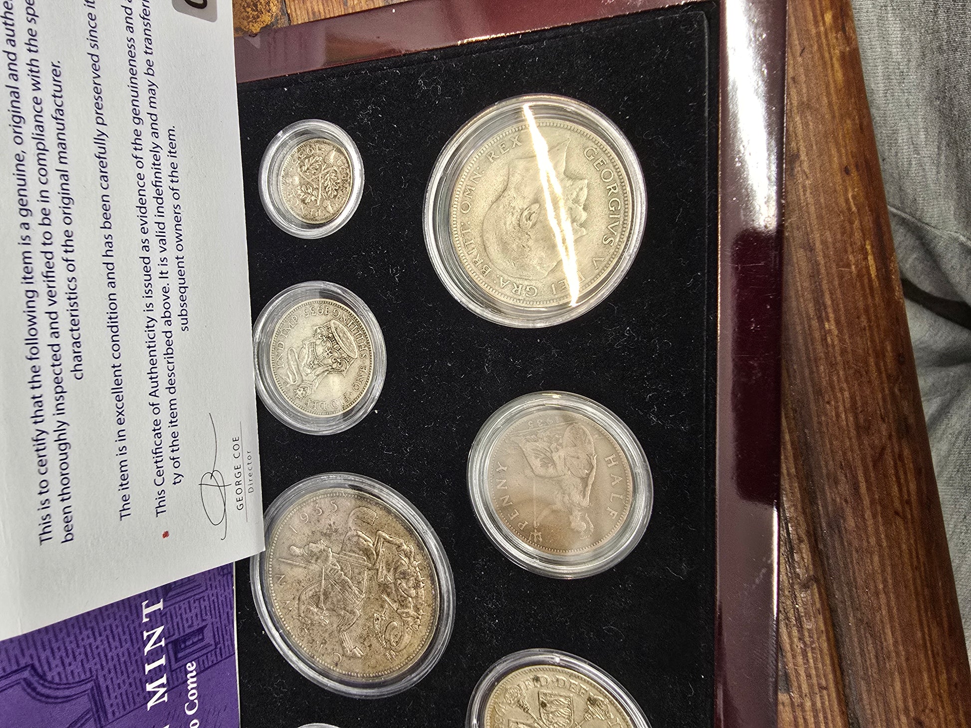 Reeves and Sons Kensington Mint 1935 Silver Jubilee coin set with box and certificate, featuring detailed silver coin images.