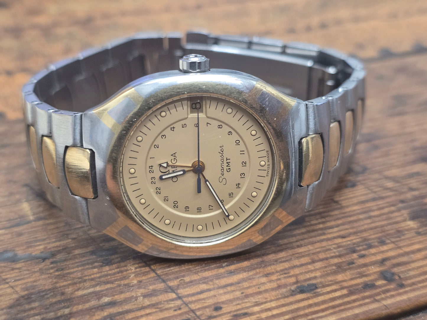 Vintage Omega Seamaster Polaris Chronograph watch with steel and gold bracelet, featuring a black dial and multiple subdials.