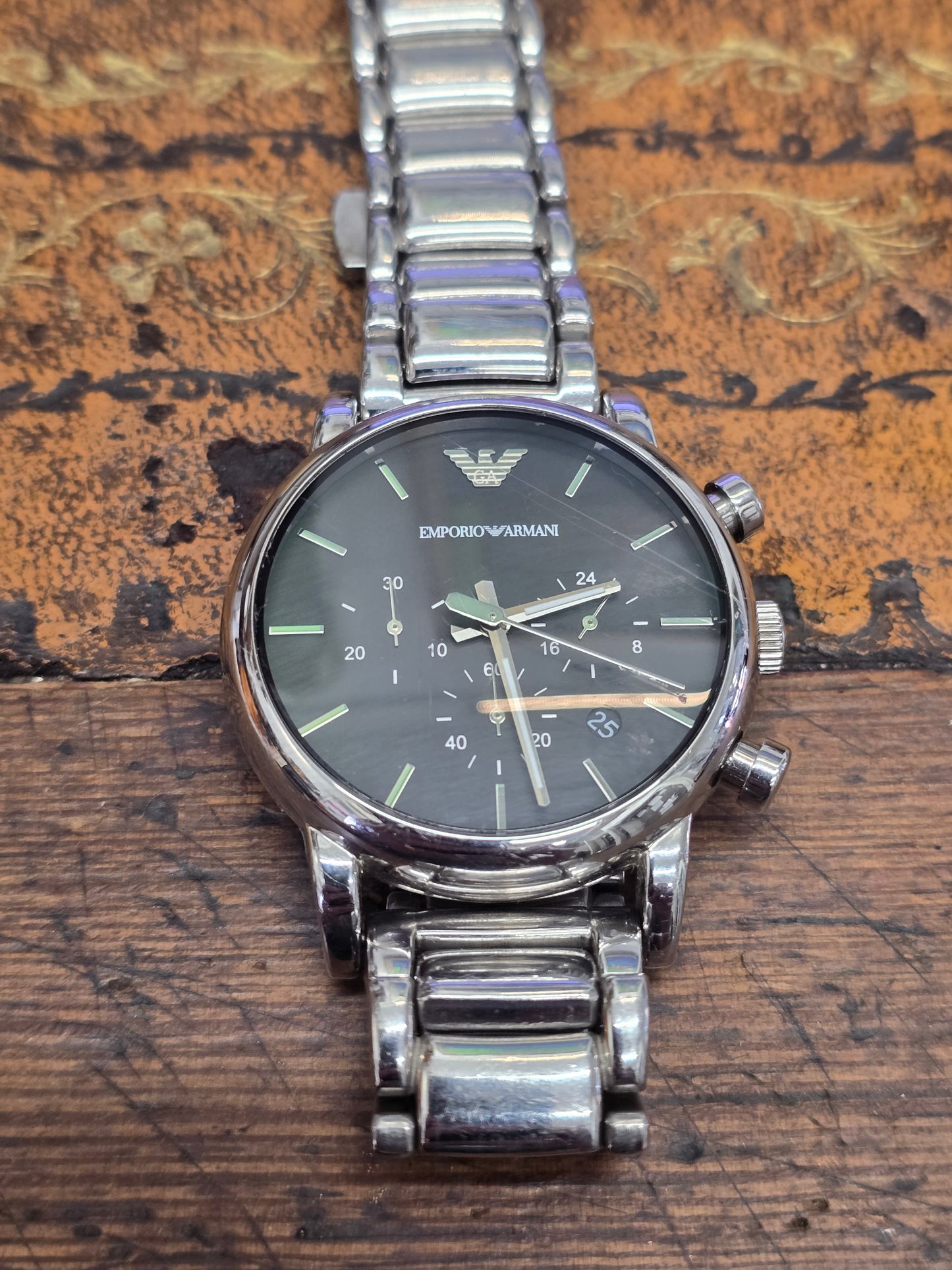 Reeves and Sons men's Emporio Armani chronograph stainless steel watch with black dial and silver hands, detailed and stylish.