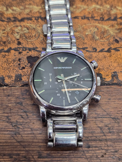 Reeves and Sons men's Emporio Armani chronograph stainless steel watch with black dial and silver hands, detailed and stylish.