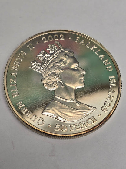 Silver 50 pence golden jubilee coin from 2002 by Reeves and Sons, showing the coin's detailed design and commemorative features.