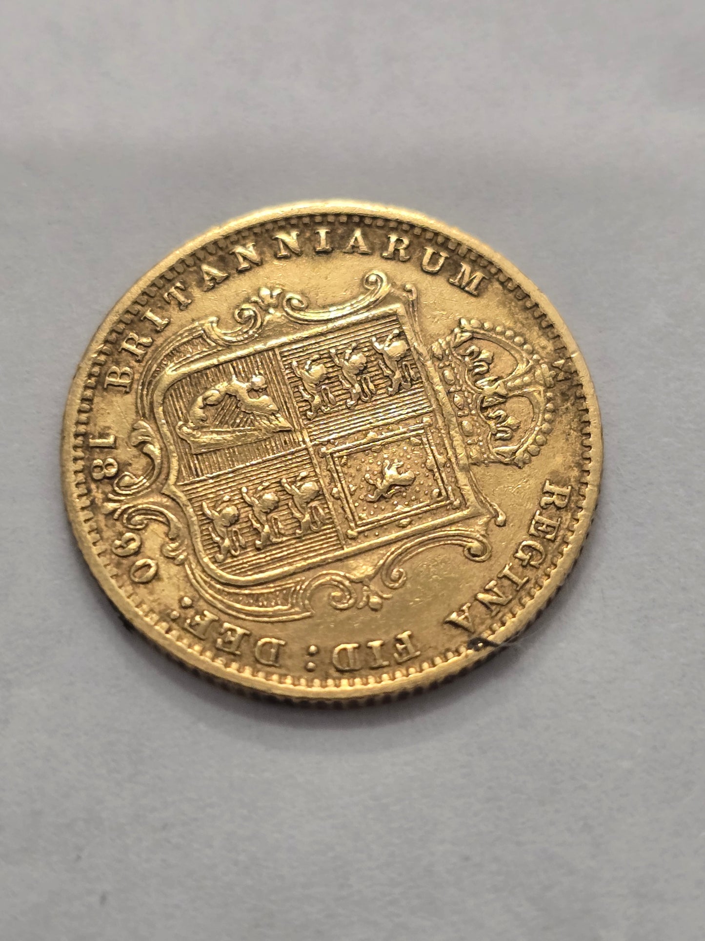 Victorian Queen Victoria 1890 half sovereign gold coin from Reeves and Sons, detailed image showing coin's design and inscriptions.