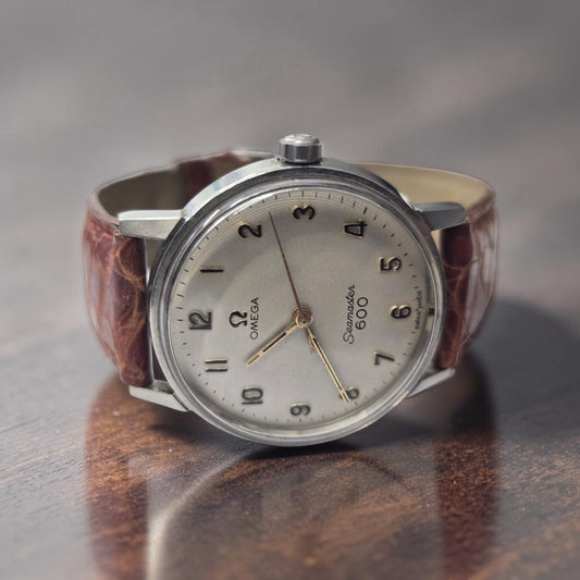 Vintage Omega Seamaster 600 Swiss-made watch with brown leather strap, featuring a classic design and detailed dial.