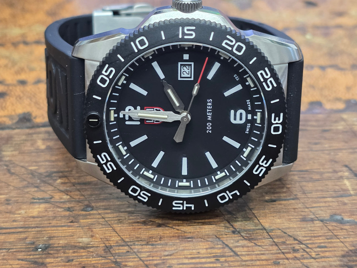 Reeves and Sons Navy SEAL style dive watch with black dial, rotating bezel, rubber strap, and water resistance up to 200 meters.
