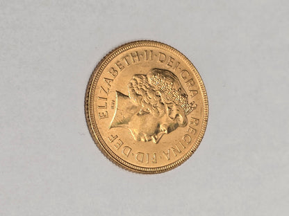 2001 Reeves and Sons full sovereign coin with detailed design and historic engravings, showcasing its classic gold appearance.