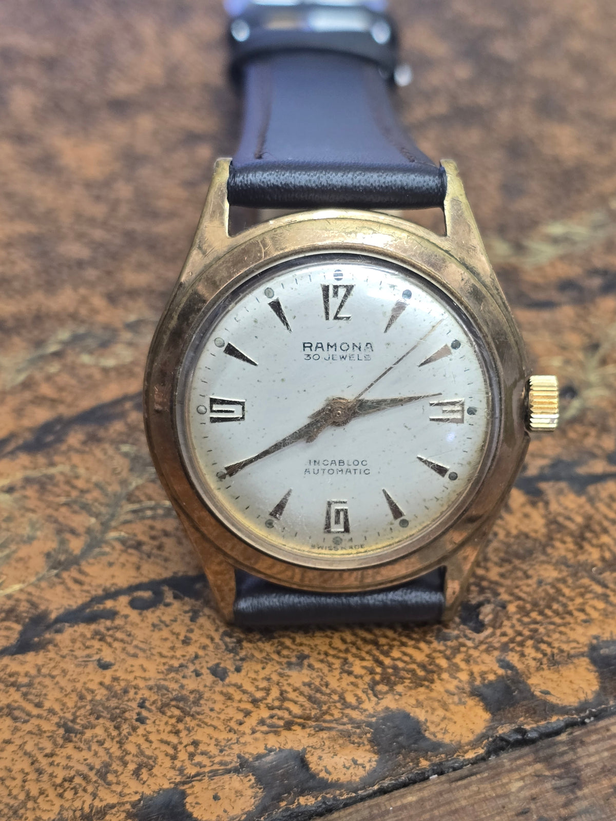 Vintage Ramona 30 Jewels Incabloc Swiss Made automatic watch by Reeves and Sons, showing the dial and classic design details.