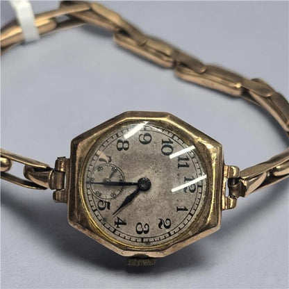 9ct yellow gold ladies Rolex watch with a classic round face and elegant bracelet, showcasing luxury and timeless style.