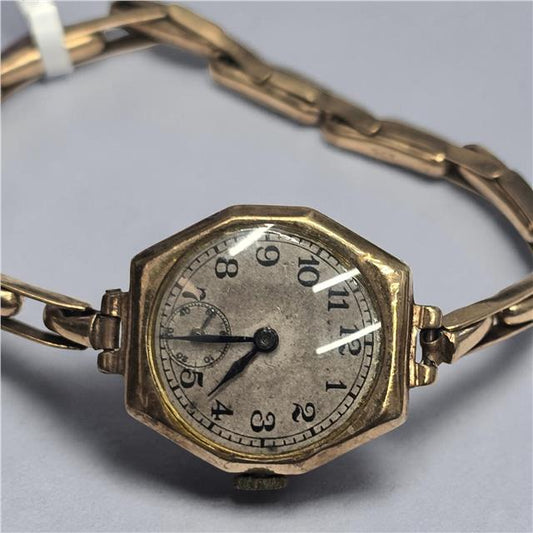 9ct yellow gold ladies Rolex watch with a classic round face and elegant bracelet, showcasing luxury and timeless style.