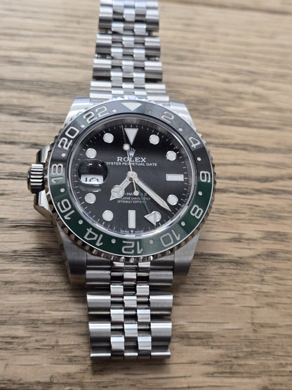 Rolex GMT Master II 126720VTTNR watch with green and black bezel, full set, featuring stainless steel bracelet and detailed dial.
