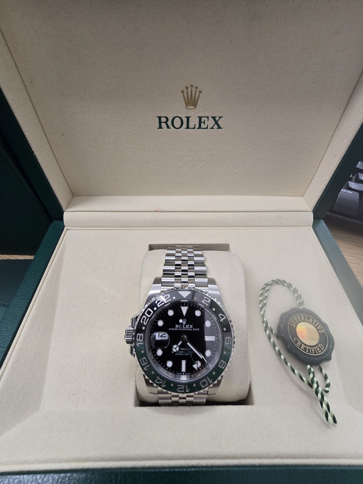 Rolex GMT Master II 126720V-TNR watch with green and black bezel, full set, featuring stainless steel bracelet and detailed dial.