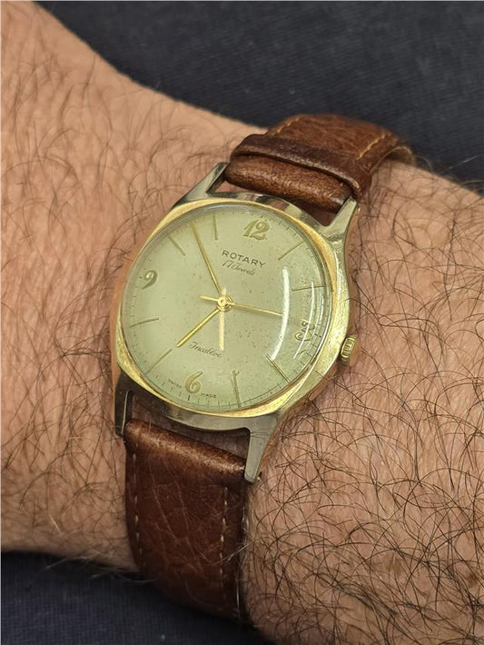 9ct yellow gold Rotary watch with a round dial and classic design, featuring a sleek gold bracelet strap.