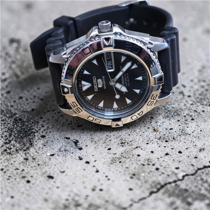 Seiko 5 Sports automatic watch with boxed papers, featuring a stainless steel case and black dial.