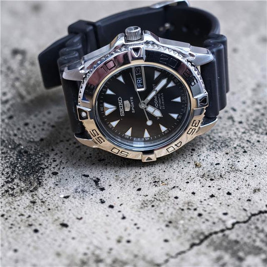 Seiko 5 Sports automatic watch with boxed papers, featuring a stainless steel case and black dial.