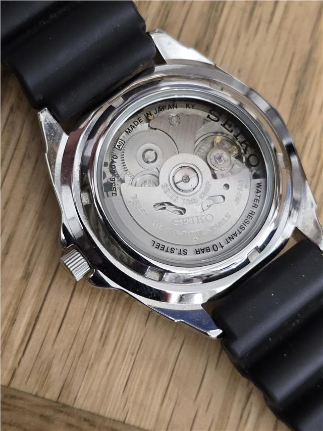 Seiko 5 Sports automatic watch with boxed papers, displaying the watch face and metal band.