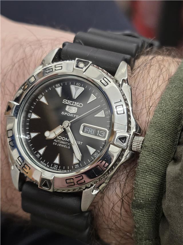 Seiko 5 Sports automatic watch with boxed papers, featuring a stainless steel band and classic dial design.