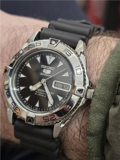 Seiko 5 Sports automatic watch with boxed papers, featuring a stainless steel band and classic dial design.