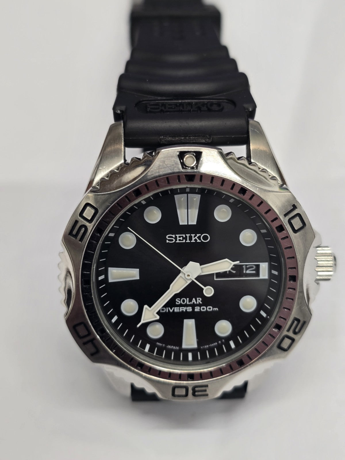 Seiko Solar Air Divers 200m watch with black dial, luminous hands, and stainless steel band, designed for diving and underwater use.