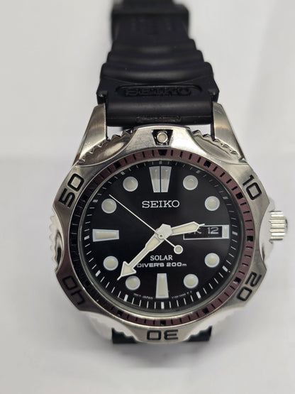 Seiko Solar Air Divers 200m watch with black dial, luminous hands, and stainless steel band, designed for diving and underwater use.
