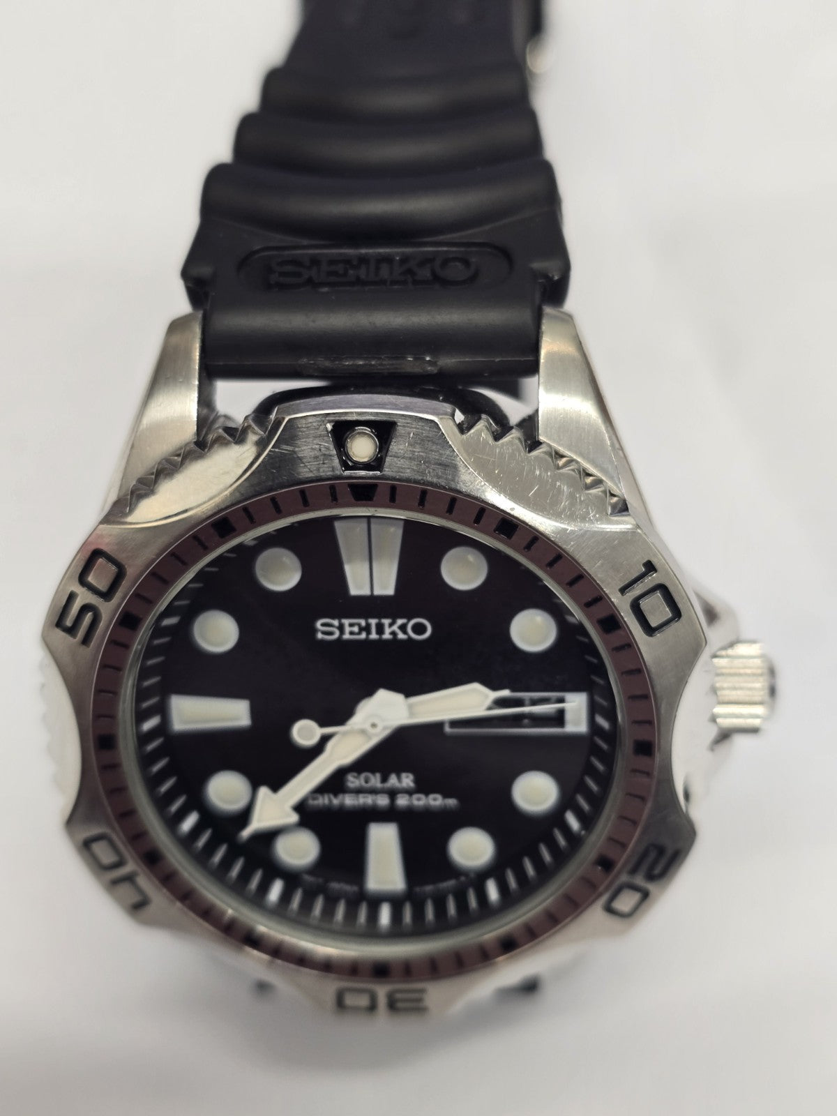 Seiko Solar Air Divers 200m watch with black dial, luminous hands, and stainless steel band, designed for professional diving.