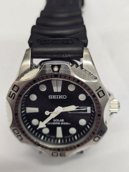 Seiko Solar Air Divers 200m watch with black dial, luminous hands, and stainless steel band, designed for professional diving.