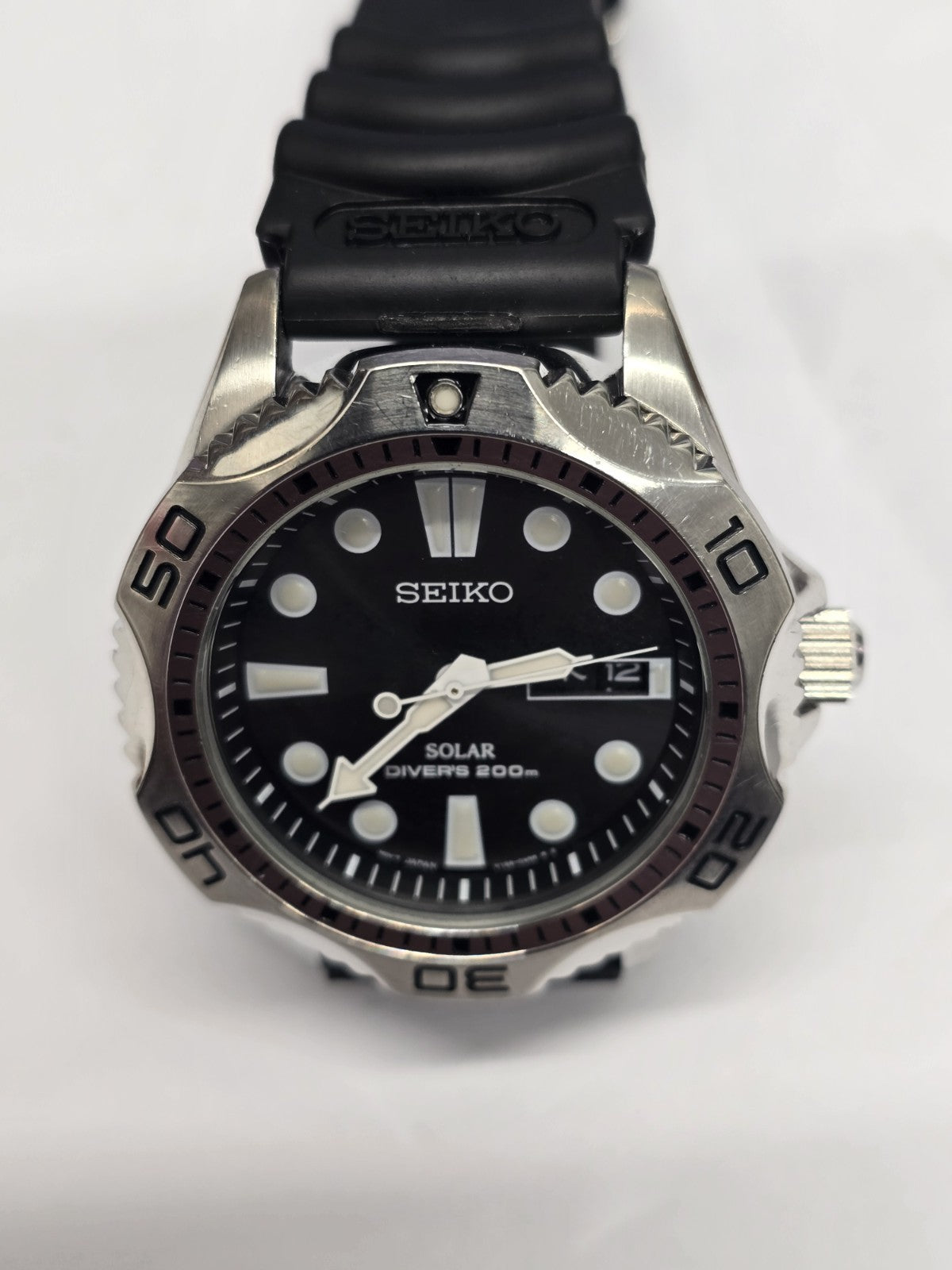 Seiko Solar Air Divers 200m watch with black dial, luminous hands, and stainless steel bracelet, designed for diving and outdoor use.