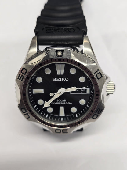 Seiko Solar Air Divers 200m watch with black dial, luminous hands, and stainless steel bracelet, designed for diving and outdoor use.