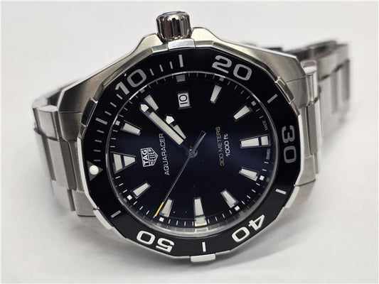 TAG Heuer Aquaracer 300M men's diving watch with black dial and stainless steel bracelet.