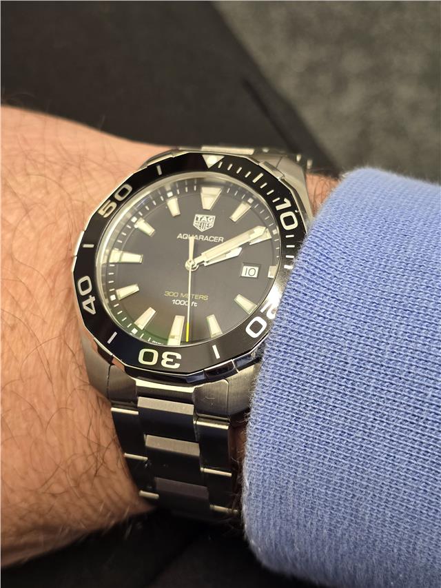 TAG Heuer Aquaracer 300 meters wristwatch with black dial and stainless steel bracelet, water-resistant sports watch.