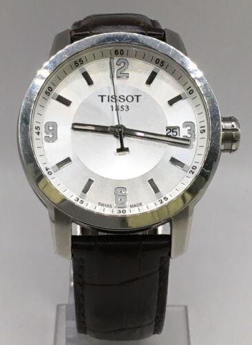 Men's Tissot watch with a sleek stainless steel band and round dial, featuring a classic design and chronograph details.