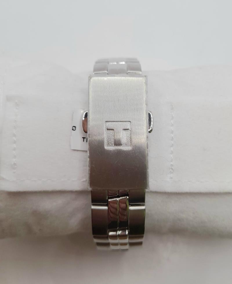 Tissot PR100 watch with box and papers, showcasing the classic stainless steel design and elegant face.